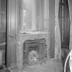 Interior, morning room, detail of Jansen designed fireplace set beneath a window and panneling