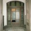 Interior. Detail of vestibule showing mosaic tile floor and leaded glass doors