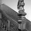 Interior. Detail of staircase lamp bearing dragon newel post