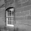 Detail of S front basement arched window and droved ashlar stonework