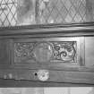 Detail of panelling with axe (Matthew) and saw (James the Lesser)
