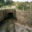 View from NE of overflow channel and tunnel beyond sluices