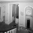 View of entrance stair hall from half-landing to N.