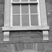 South frontage, detail of first floor carved window cill.