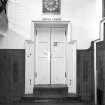 Interior view of Glasgow School of Art showing lecture theatre door in basement from E.
