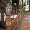Interior. View of stair hall from SSE with lamp bearing dragon newel