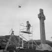 Geoffrey B Quick, RCAHMS, photographing St Martin's Cross, Iona.