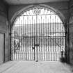 Holyrood Road front, entrance archway and wrought-iron gate, view from N