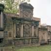 View of funerary monument on west wall of churchyard.