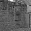 Sacrament house, blocked arched window and grave-slab.