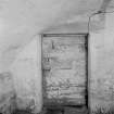 Detail of door in cellar on ground floor of main block, Auchenbowie House.