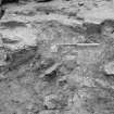 Excavation photograph : 128 showing band of coal chips 164 edging natural rock, looking south.