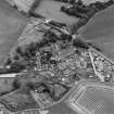Oblique aerial view of the village of Kilrenny centred on the church, taken from the WNW.