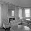 Interior view of Corsindae House showing drawing room with fireplace.