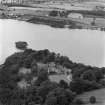 Oblique aerial view of Lochmaben Castle from S, showing excavations in progress.