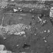 Edinburgh Castle, settlement. Excavation photograph: area H - cobbling on bedrock in N part of area, wall (?) 442 to N.