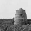 View of Dolphingstone dovecot from S showing a man with a camera beside it.