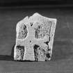 View of fragment of cross slab carved in relief with a cross with forked terminals from Whithorn.