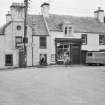 General view of The Cross and Sydbar House on the east side of Willoughby Street, Muthill, showing the premises of S L Macintosh.