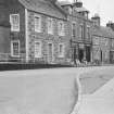 General view of buildings on the south side of Drummond Street, Muthill, including St Nicholas and Hillview.