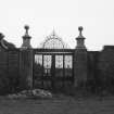 General view of wrought iron gates into walled formal garden