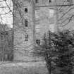 View of Aboyne Castle in a derelict state through trees.