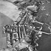 Oblique aerial view centred on the village and harbour, taken from the SE.