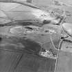 Oblique aerial view centred on the quarry with the village adjacent, taken from the S.