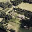 Oblique aerial view of Abbotsford centred on the country house with tea room, gardens and stables adjacent, taken from the WNW.