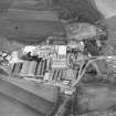 Oblique aerial view centred on the paper mill with the houses and office adjacent, taken from the SE.