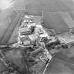 Oblique aerial view centred on the paper mill with the houses and office adjacent, taken from the ENE.