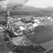 Oblique aerial view centred on the paper mill with the houses and office adjacent, taken from the N.
