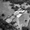 Oblique aerial view centred on country house from NE.