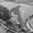 Oblique aerial view centred on country house from NE.