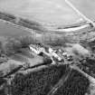 Oblique aerial view centred on country house from SE.