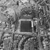 Oblique aerial view of Methil centred on East Fife football ground with Aberhill Primary School adjacent, taken from the SW.