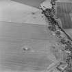 Oblique aerial view of Dunino Airfield centred on the remains of buildings and the control tower, taken from the SW.