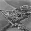Oblique aerial view of the village of Kilrenny centred on the church, taken from the E.
