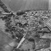Oblique aerial view of the village of Kilrenny centred on the church, taken from the NW.