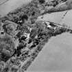 Oblique aerial view centred on the country house and farmsteading, taken from the NE.