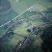 Oblique aerial view centred on the remains of the abbey with the walled garden, house and farmsteading adjacent, taken from the NE.