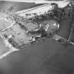 Oblique aerial view centred on the remains of the castle taken from the SW.