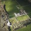 Oblique aerial view centred on the country house and walled garden with the farmsteading adjacent, taken from the SSW.