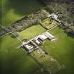 Oblique aerial view centred on the country house and walled garden with the farmsteading adjacent, taken from the NE.