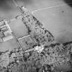 Oblique aerial view centred on the country house and walled garden with the farmsteading adjacent, taken from the WNW.