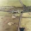 Oblique aerial view centred on the farmsteading, taken from the NW