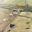 Oblique aerial view centred on the farmsteading, taken from the NW