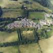 Oblique aerial view centred on the hospital and churches, taken from the SE.