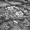 Oblique aerial view centred on the hospital with the school adjacent, taken from the NNE.
