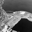 Oblique aerial view centred on the harbour and fishmarket with the flour mills, docks and the breakwater adjacent, taken from the E.